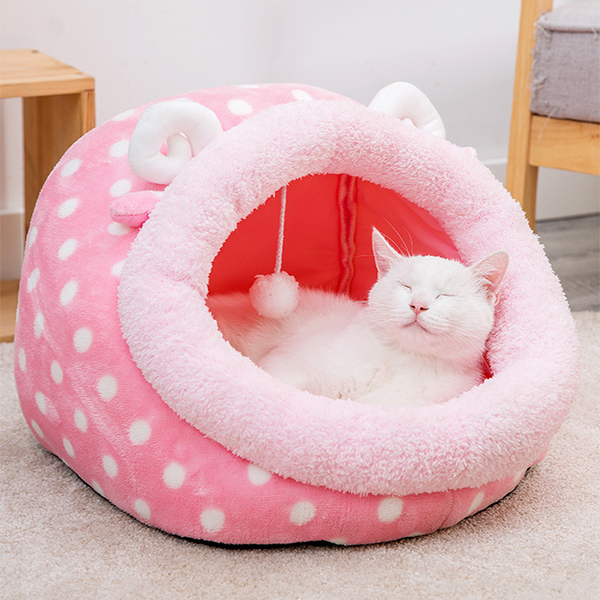 Cat sleeping in a warm semi-enclosed cat bed.